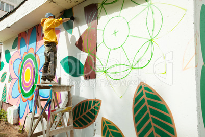 Image of graffiti artist working on street