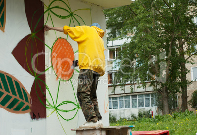 Image of young graffiti artist at work