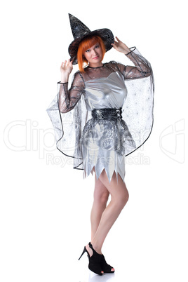 Beautiful red-haired model posing in witch costume