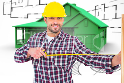 Composite image of handyman using measure tape on wooden plank