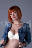 Hot redhead girl posing in seamless bra and jacket