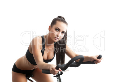 Portrait of sexy young woman posing on bike