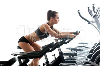 Image of sexy woman exercising on stationary bike