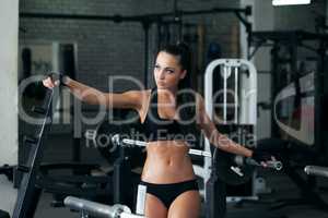 Sexy young girl posing with fitness equipment