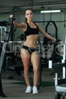 Seductive athletic model posing in gym