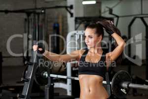 Charming female athlete posing in gym