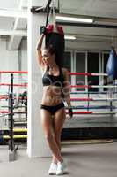 Seductive female boxer posing in gym