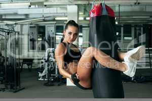 Sexy model posing jumped on punching bag