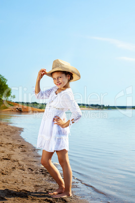 Smiling fashionable girl posing in park