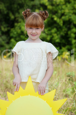 Portrait of adorable red-haired girl in park