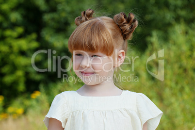 Adorable red-haired girl on green background