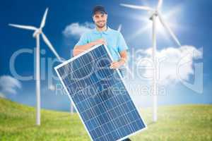 Composite image of smiling construction worker holding solar pan