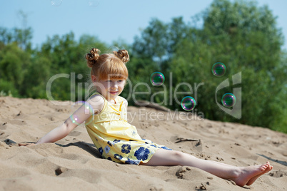 Amusing red-haired girl resting on beach