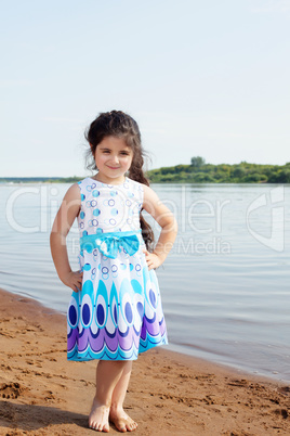 Smiling little model posing on river background