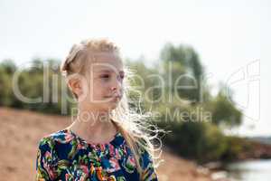 Portrait of dreamy girl with flying hair in wind