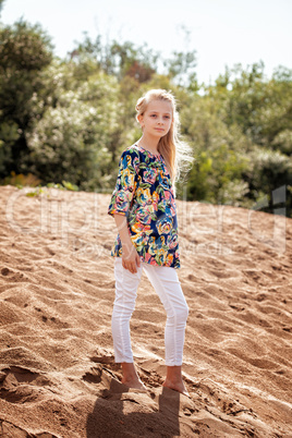 Young model posing in casual clothes on beach