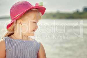 Portrait of beautiful little blond girl in hat