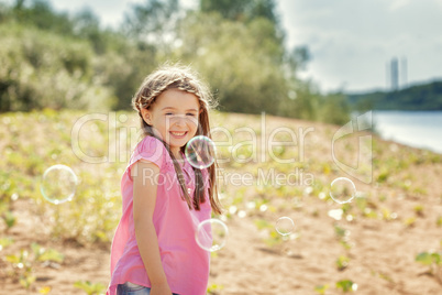 Beautiful little girl having fun in park