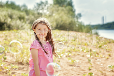 Portrait of merry little girl posing at camera