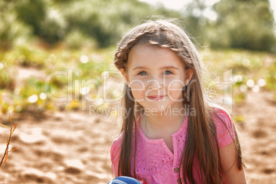 Portrait of attractive little girl in park