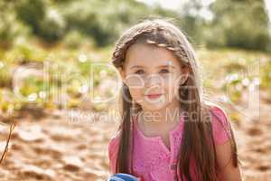 Portrait of attractive little girl in park
