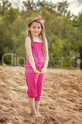 Shy pretty girl posing on beach in park
