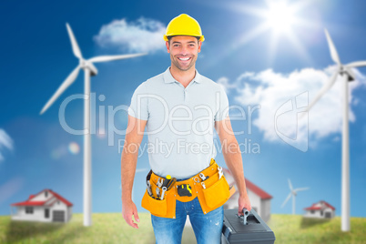 Portrait of smiling handyman holding toolbox