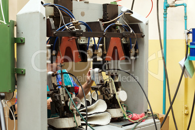 Image of busy worker making shoes