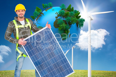 Composite image of smiling handyman with solar panel
