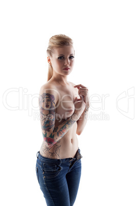 Studio shot of tattooed woman with pierced nipples