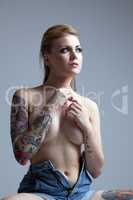 Portrait of beautiful slim model with tattoos