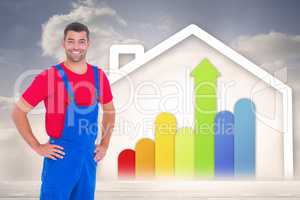 Composite image of happy handyman in overalls with hands on hip