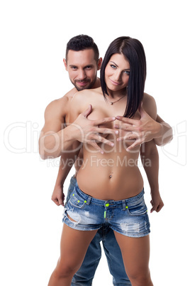 Cheerful man covers bare breasts of his girlfriend