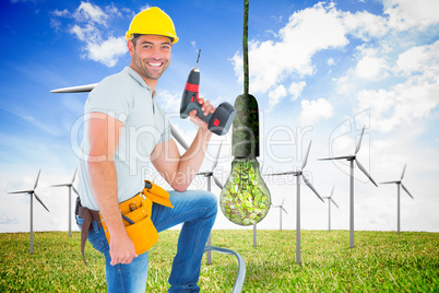 Composite image of confident handyman holding power drill while