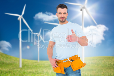 Composite image of handyman wearing tool belt with thumbs up