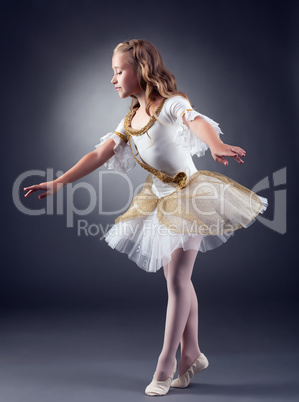 Cute little ballerina dancing in studio