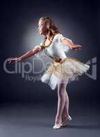 Adorable little ballerina dancing in studio