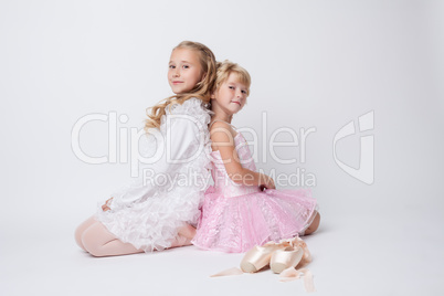 Blonde sisters posing with pointes in studio