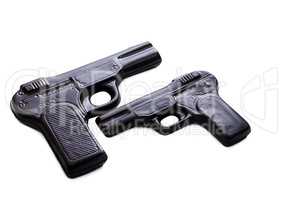 Two pistols made of dark chocolate, close-up
