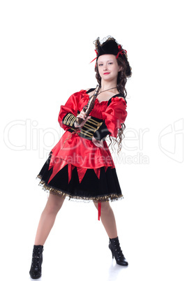 Bold young girl posing in pirate costume with gun