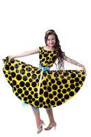 Curly-haired fashionista posing in polka dot dress