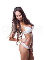 Long-haired model posing in erotic lingerie