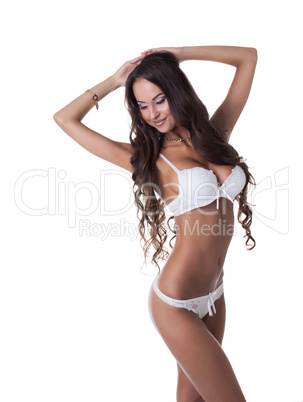 Pretty slim girl posing in white erotic lingerie
