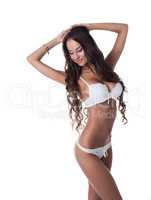 Pretty slim girl posing in white erotic lingerie