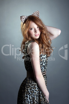 Image of cute red-haired girl in leopard costume