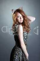 Image of cute red-haired girl in leopard costume