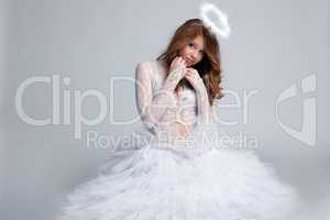 Image of pretty red-haired girl dressed as angel