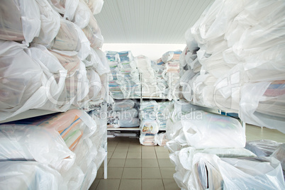 Image of racks with clean clothes in laundry room