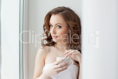 Portrait of beautiful woman posing with cup