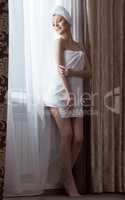 Beautiful slim woman posing after shower